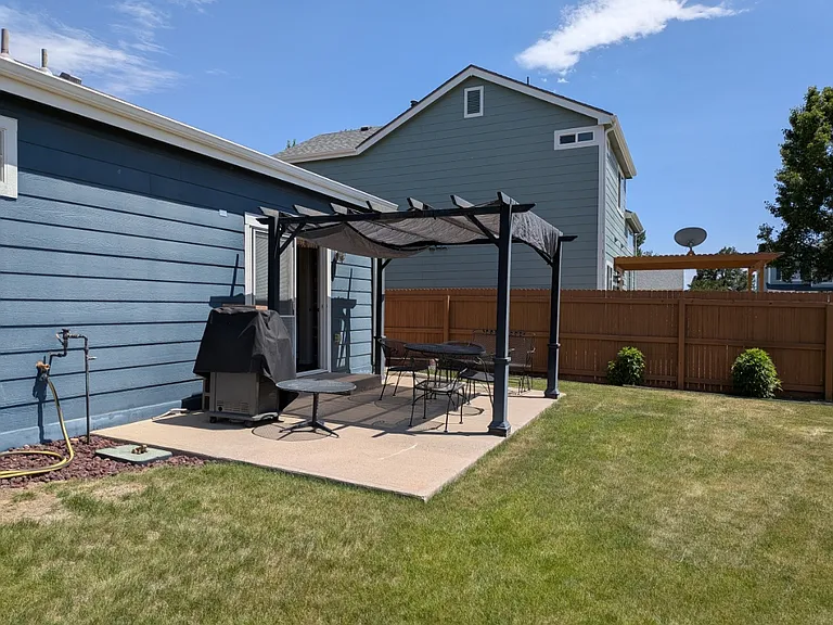 Back patio with grill and furniture included