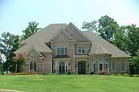 Four sided brick home on championship golf course with three car garage