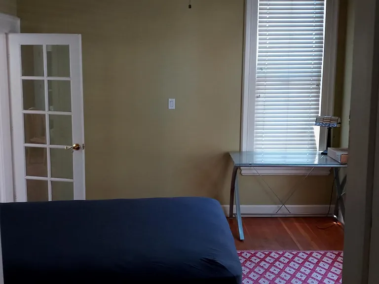 downstairs bedroom, hardwood floors and tall ceilings, desk lamp