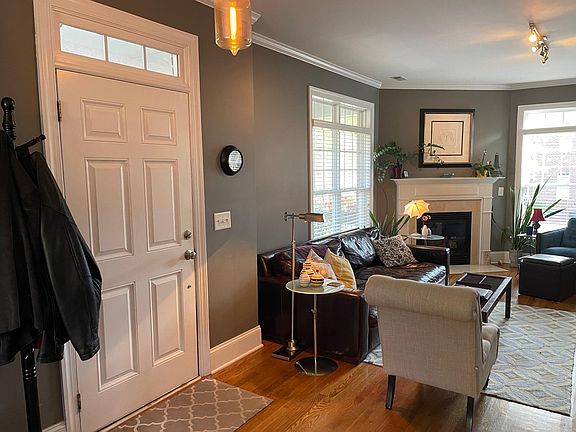 View of living room and entrance. Living room features gas fireplace.