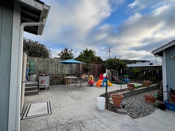 Spaces backyard with terraced area for planting vegetables or other items.