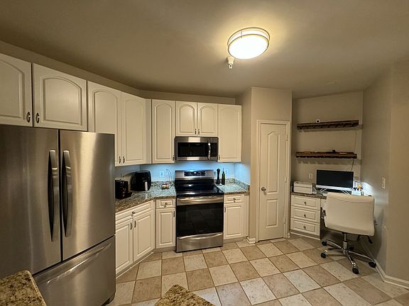 kitchen with granite countertops and new stainless steel appliances