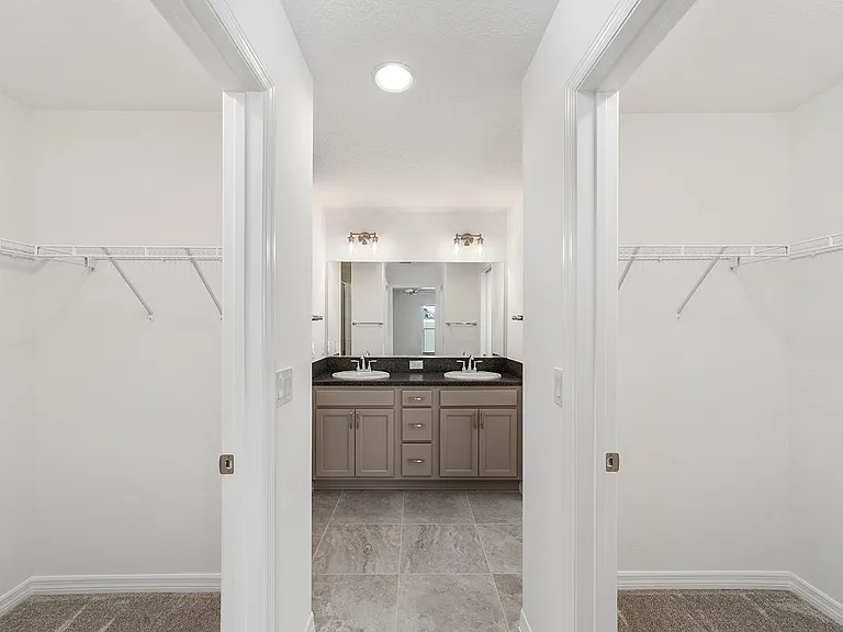 Master bedroom 2 walk-in closets and double-sink bath_luxury and storage perfected.