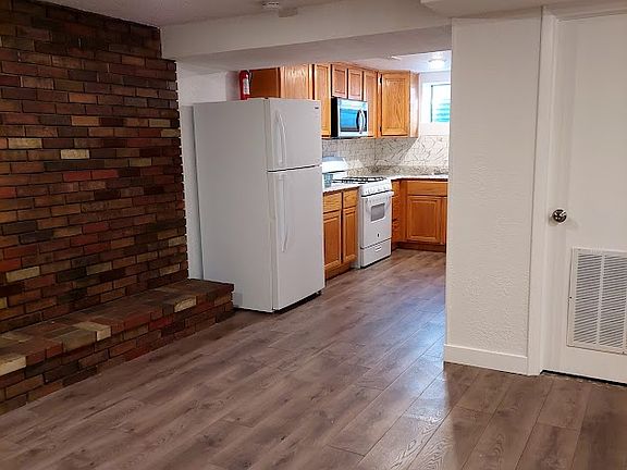 The kitchen opens to the side of the living room. There is extra storage in the furnace room (closed door in pic).