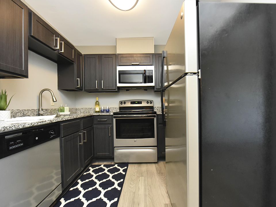 Kitchen with granite counters, stainless appliances, and modern cabinetry
