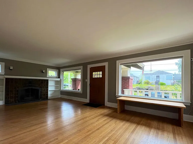 main entrance to living room with open gas fire-place