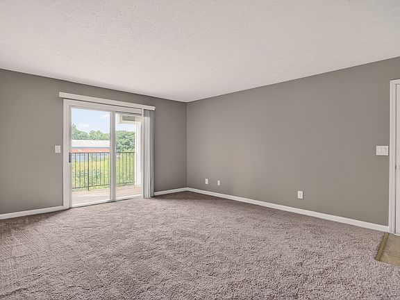 Spacious living room with carpet