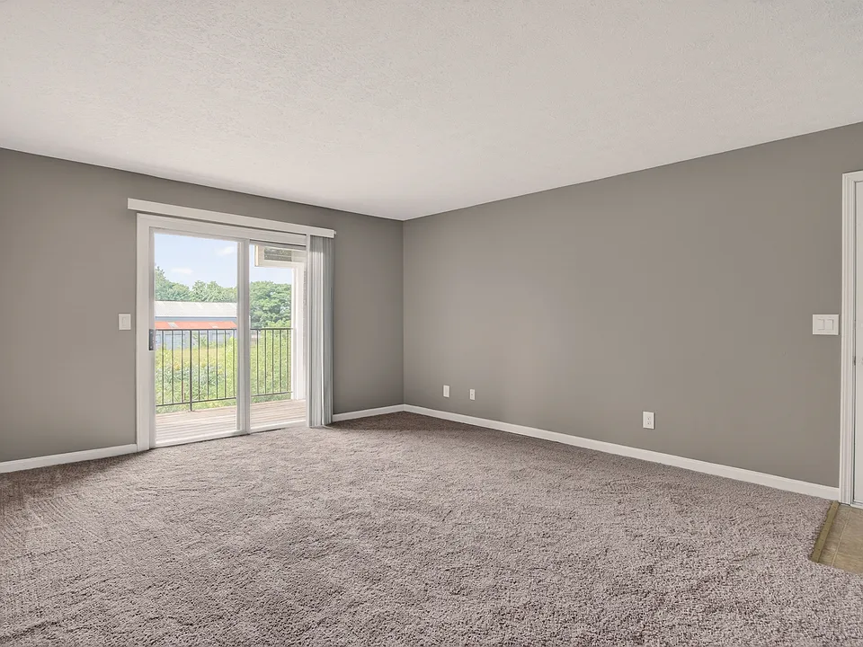 Spacious living room with carpet