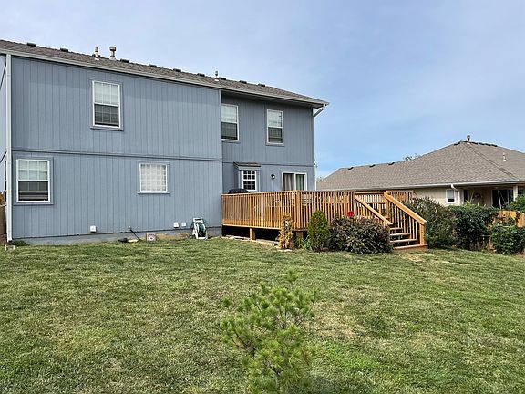 Fenced backyard featuring large deck