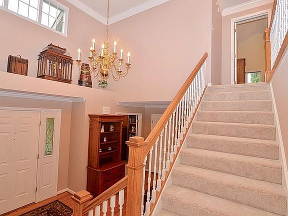 Lots of light in the large entry with plant shelf. BRAND NEW carpeting less than 1 week old on stairs and on the upper level.