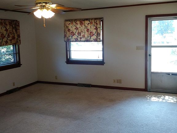 Living area, fireplace on left, looking out of front door