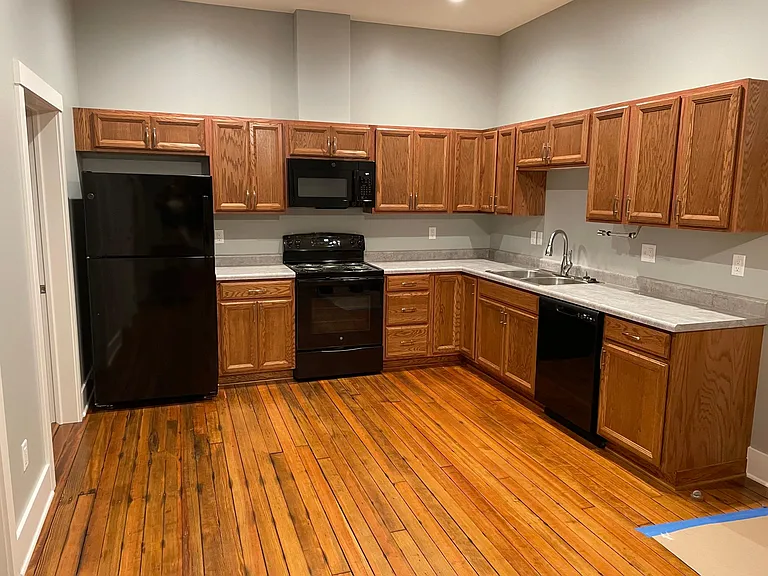 New kitchen cabinets, appliances and original refinished floors. Main room looking south.