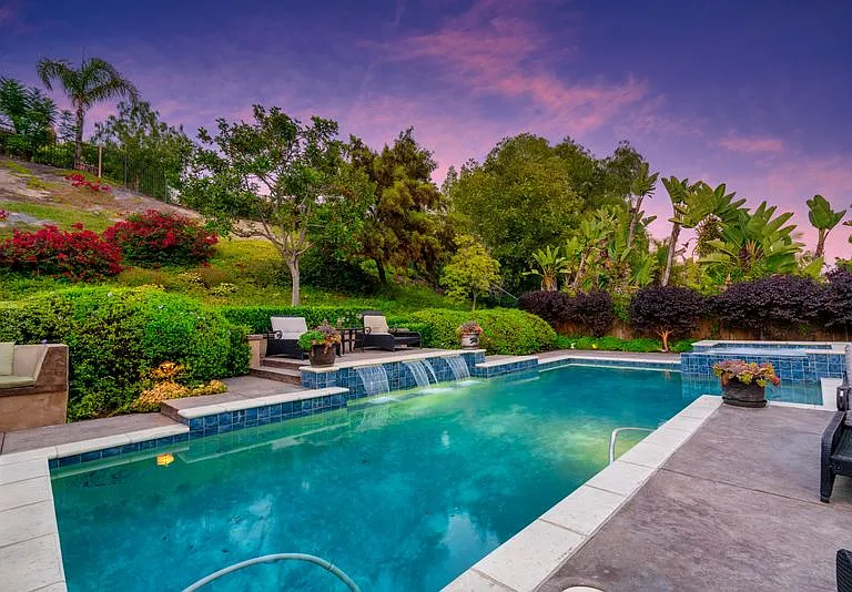 View from the home is a lush hillside, sunning deck and waterfalls.