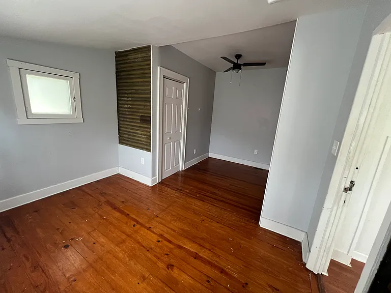 Bedroom 1 with exposed shiplap and custom decorative shelves. 2 closets!!