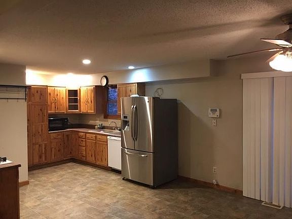 Large kitchen with dishwasher, refrigerator and gas stove.