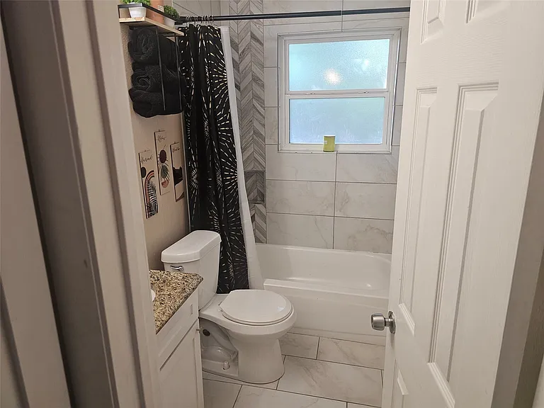 Full bathroom with vanity and shower / bath combo with shower curtain