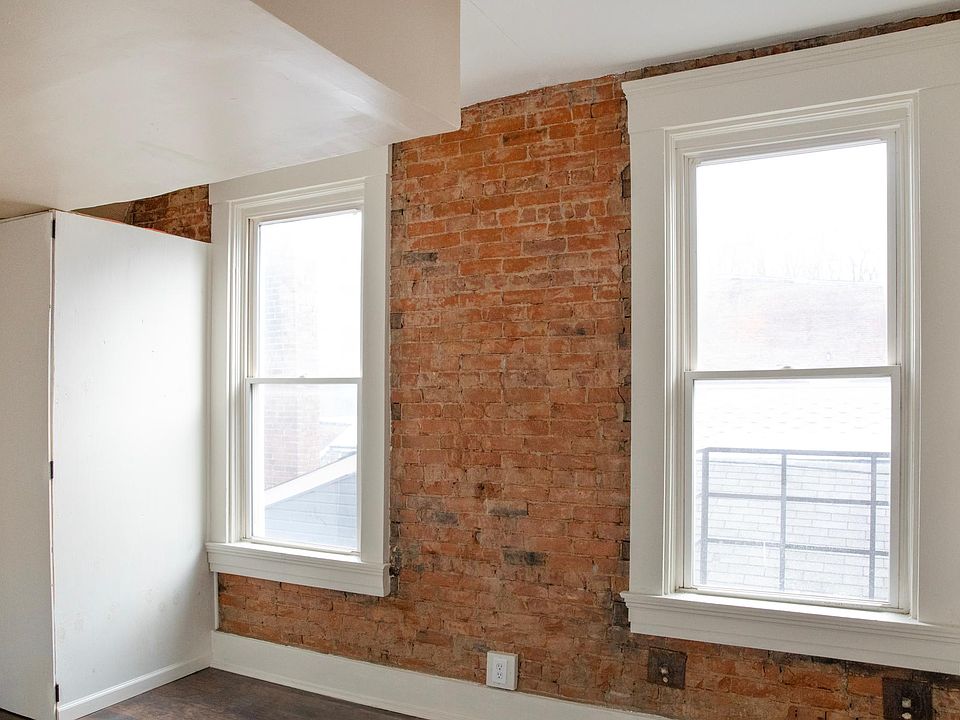 View of brand new storage closet with storage space inside the closet and on top. In front entranceway/ dining room. The 2 windows can be opened and let in plenty of natural light! Perfect spot for a kitchen/dining room table.