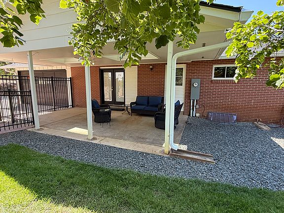 The private covered, east-facing patio with a fenced-in yard, mature trees, and healthy lawn, offer a nice entertainment and relaxation area.