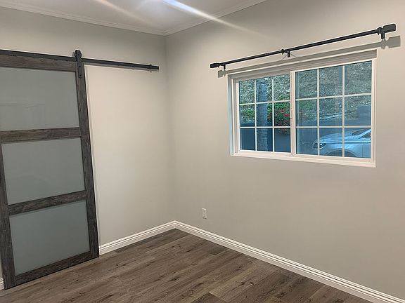 Bedroom w/ barn door to bath