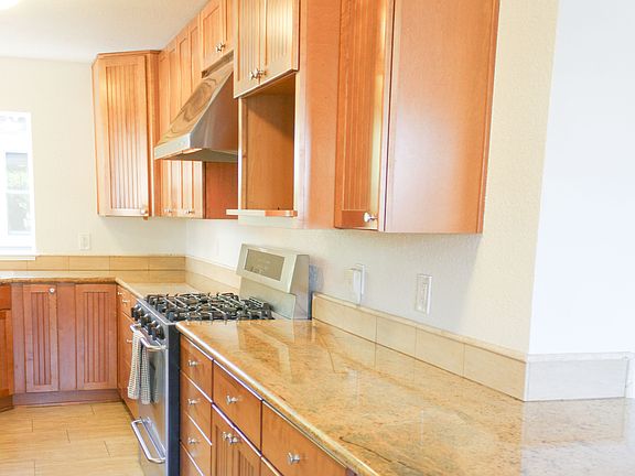 Counter seating for three at entrance to kitchen. Granite countertops.