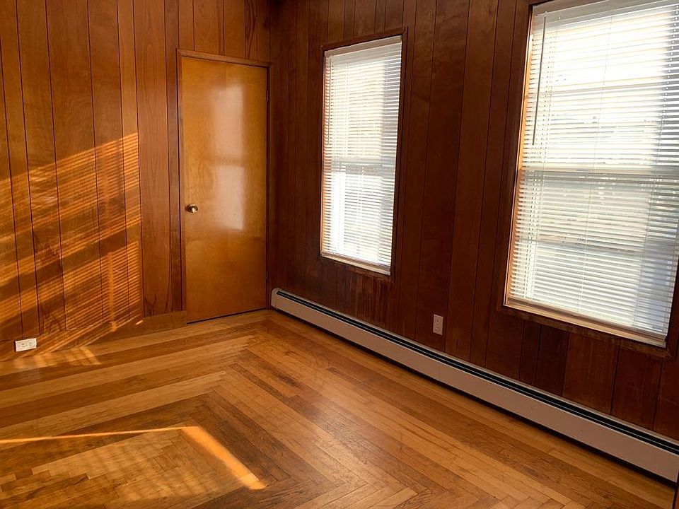 Dining area with closet showing gorgeous inlaid hardwood floor design