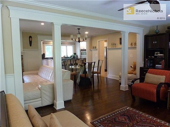 LIVING ROOM OPENING TO HEARTH AREA AND DINING ROOM
