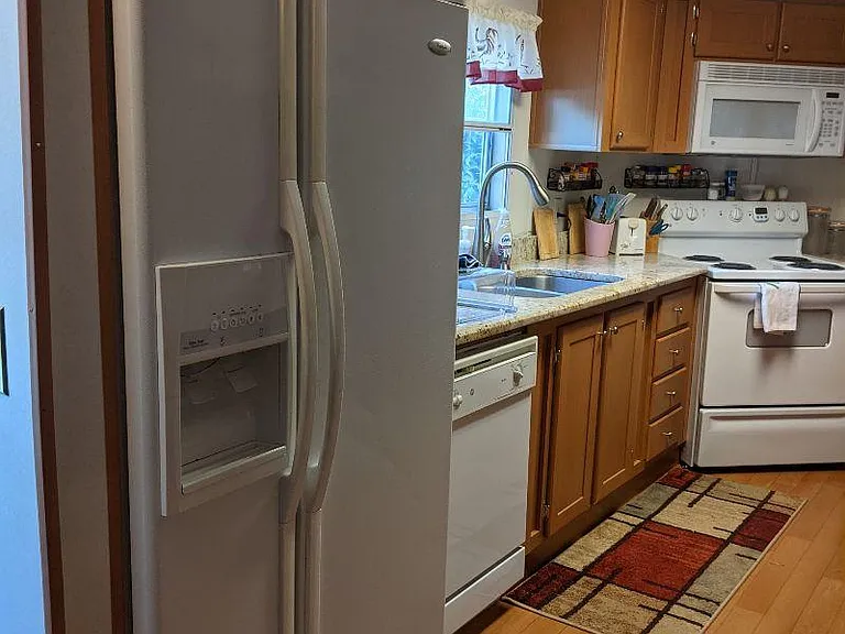 Kitchen featuring side by side fridge/freezer with ice and water in the door.