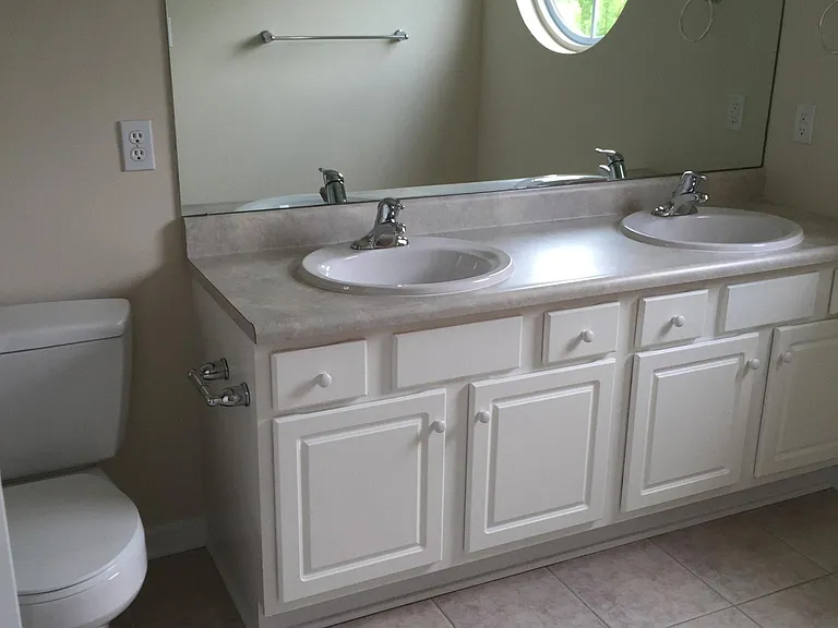 Master bath features double sinks and walk in shower with seat