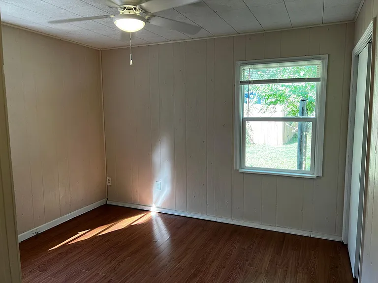 Bedroom number two with large newer windows.
