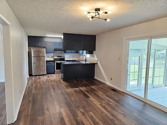 View from side entrance. Dining room facing kitchen, living room to the left.