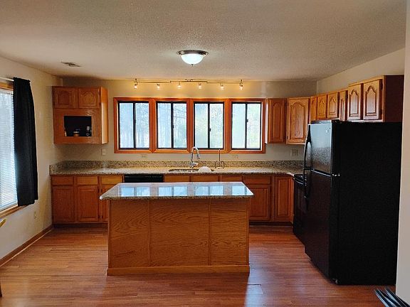 Large kitchen with granite counter tops, newer dishwasher, microwave stove and fridge