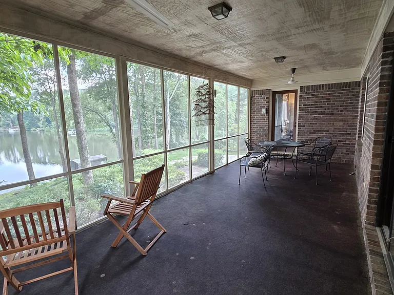 Sunroom looking over lake. Doors from the kitchen and living room.
