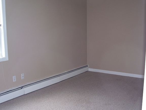 Bedroom with large closets and large windows.