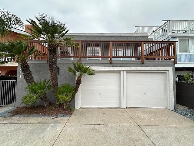 Exterior of home with extra wide driveway.