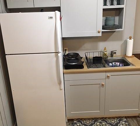 In-law suite kitchen with full sized refrigerator.