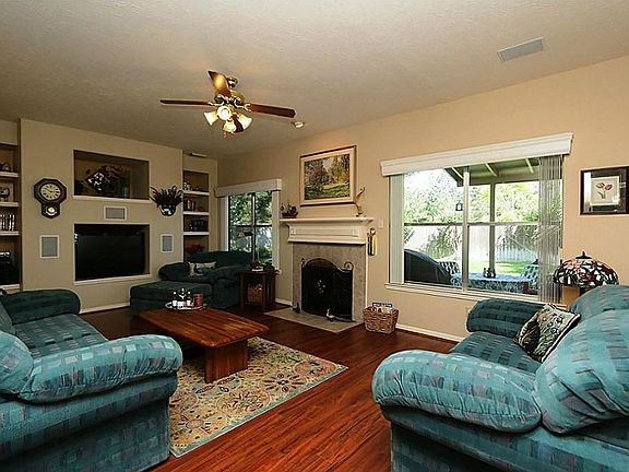 Warm and inviting den with custom built-ins, gas log fireplace and a fantastic view of the garden