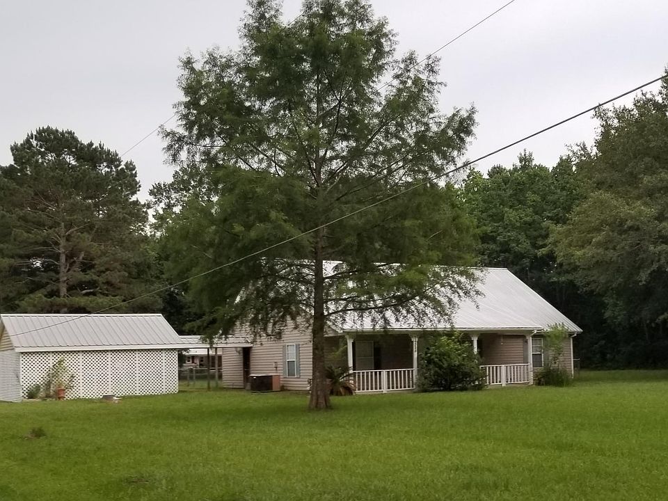 Front view of house and 2 car carport with covered walkway