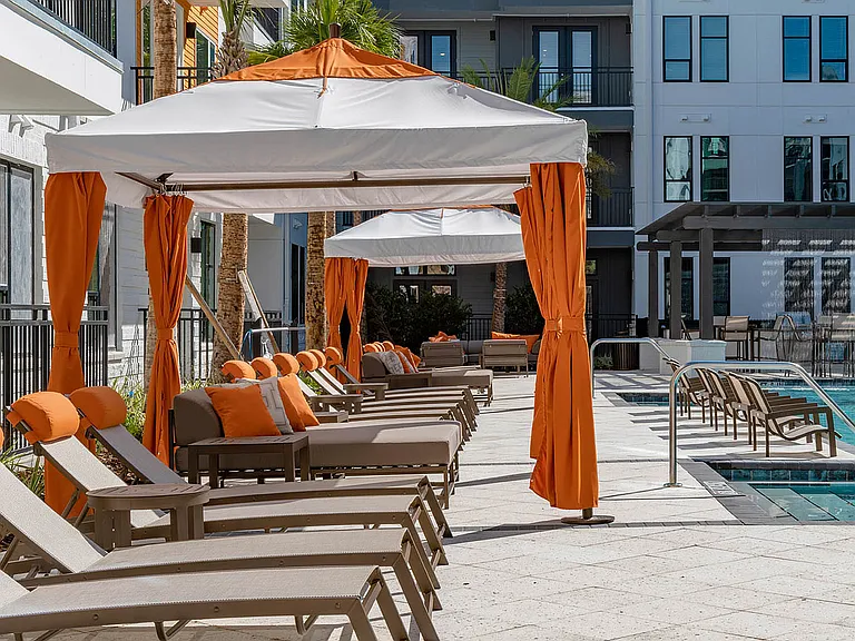 Relax in style at this inviting poolside oasis, complete with chic loungers and cabanas.