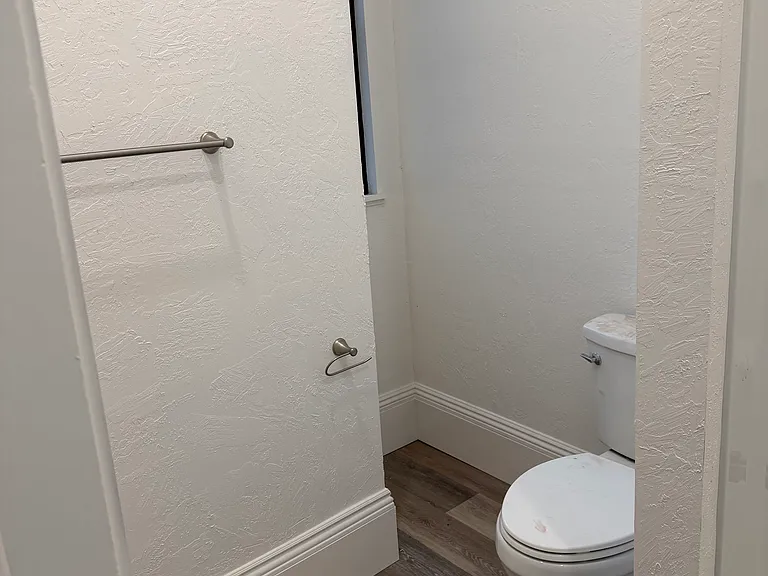 The bathroom includes a new vanity, mirror, toilet, and bathtub. A new shower rod and curtain are also already installed.