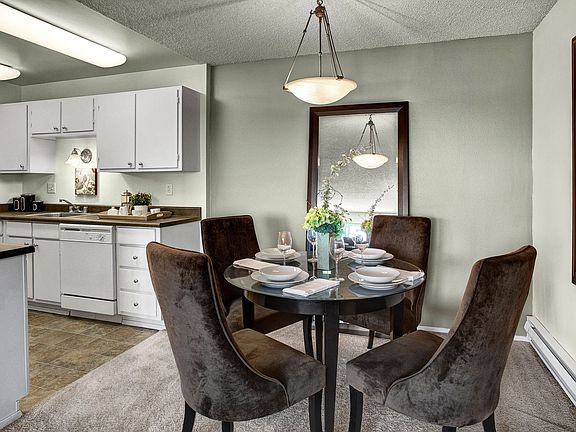 Dining area with overhead lighting and easy access to the kitchen