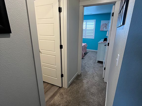Hallway to 2 bedrooms, hall bathroom and coat closet.