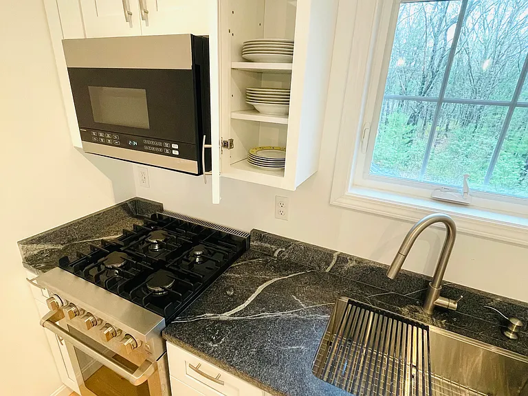 Kitchen: gas stove and oven, microwave with convection oven and air fryer, large farmhouse sink, dishes, pots, pans, cuttlery included