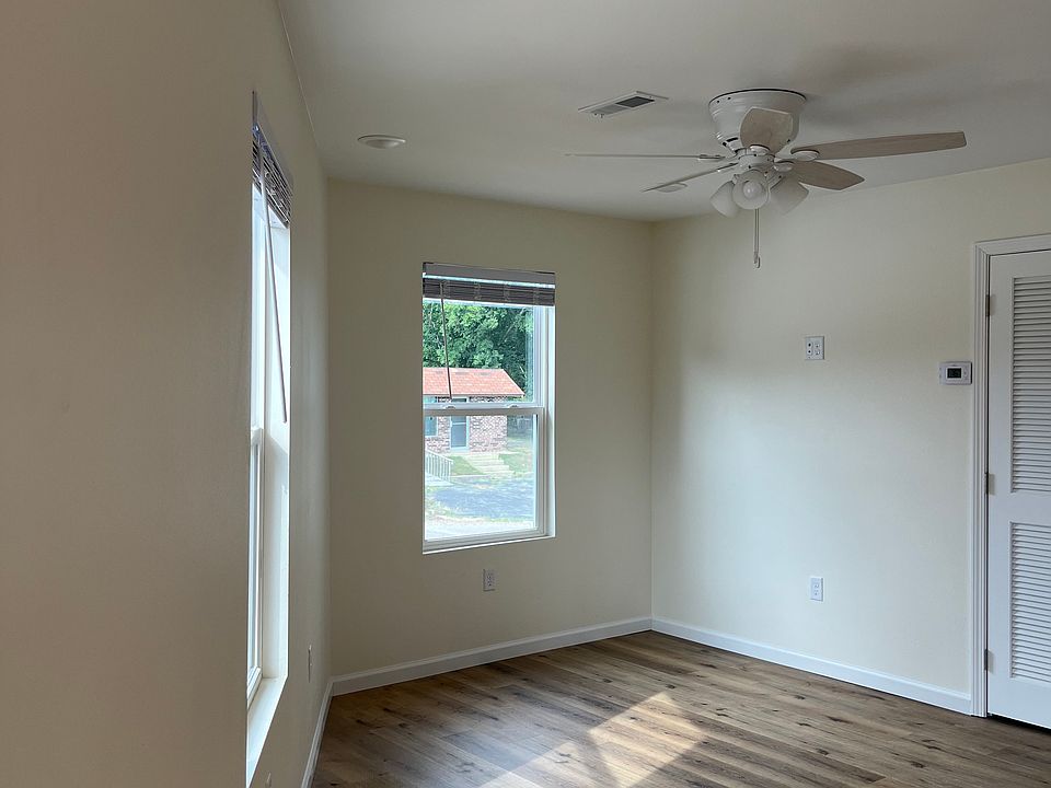 Other portion of living-room. The water heater and air/heat unit is behind the louvered door.