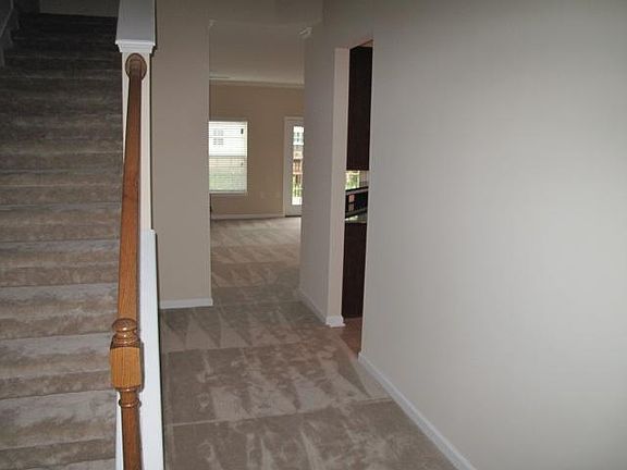 Carpet has been removed from hallway and living room, and is now wood planking.