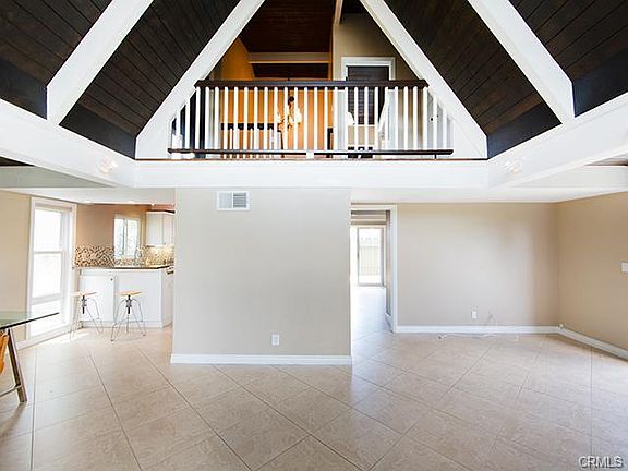 Open floorplan with high ceilings in family room space.