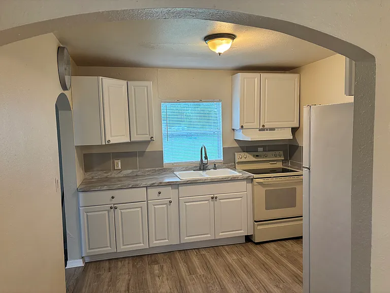 Kitchen with stove and a refrigerator