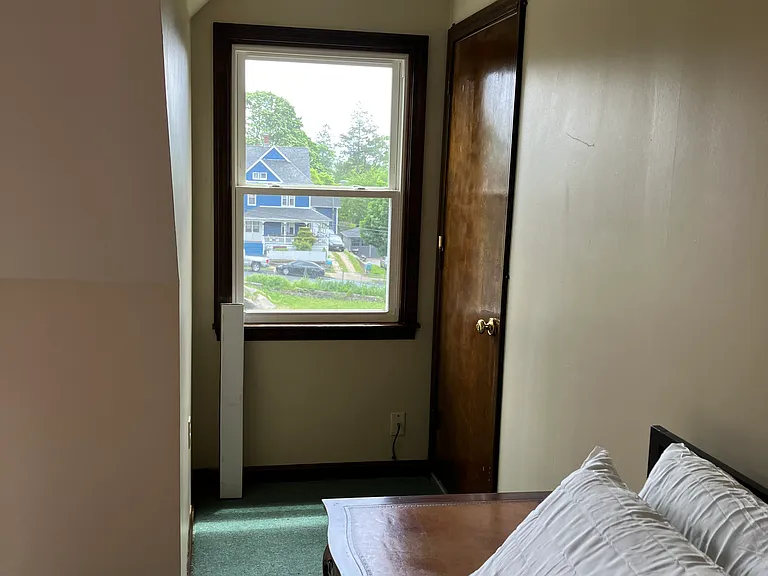 Bedroom with a Queen bed and rear exit
