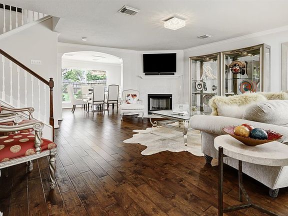 Warm and cozy fireplace, crown molding enhance the spacious living room and ideal for entertaining!