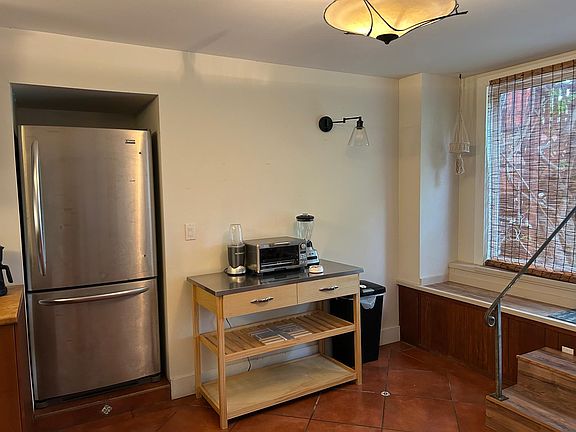 Kitchen island with blender, toaster oven and additional storage