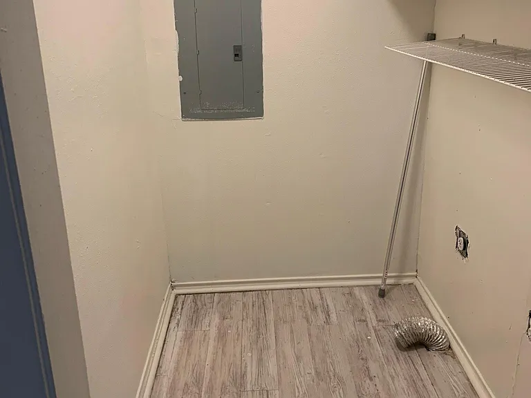 Laundry room with storage off the hall from kitchen to the primary bedroom.